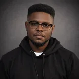 Daniel Adesoji wearing glasses and a black hoodie